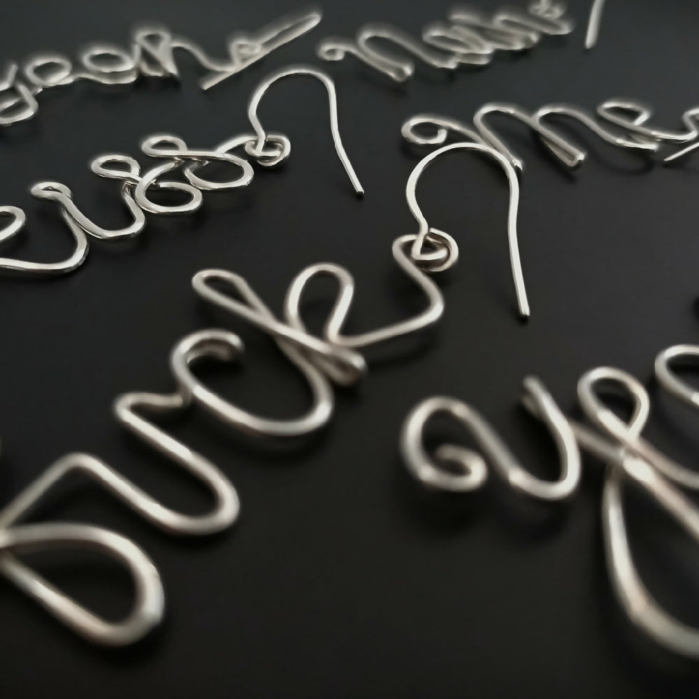 Bite Me Curse-ive Word Dangle Earrings