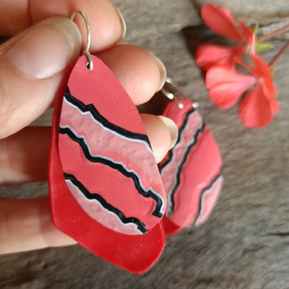 upcycled handmade earrings pink red trianglular in hand