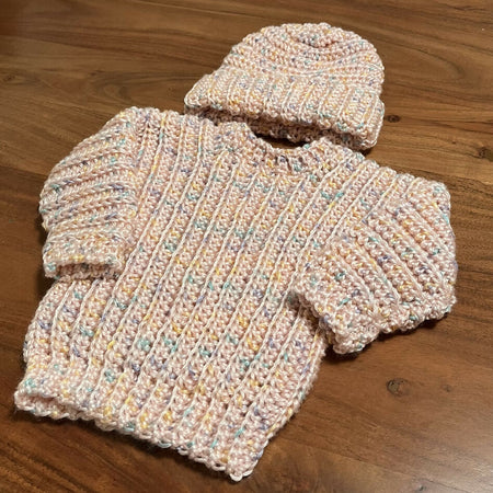 Hand crocheted baby’s jumper and matching beanie