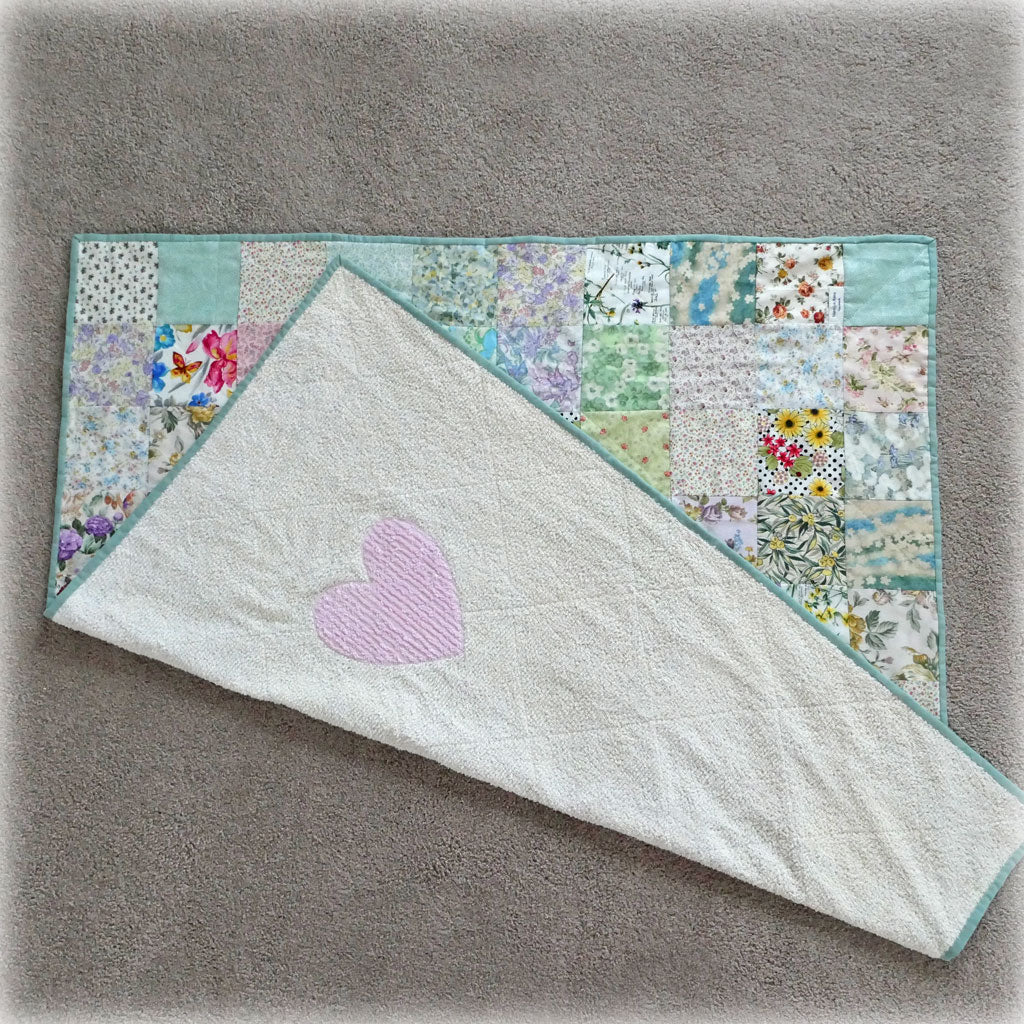 Handmade knee rug with chenille backing. Pretty florals