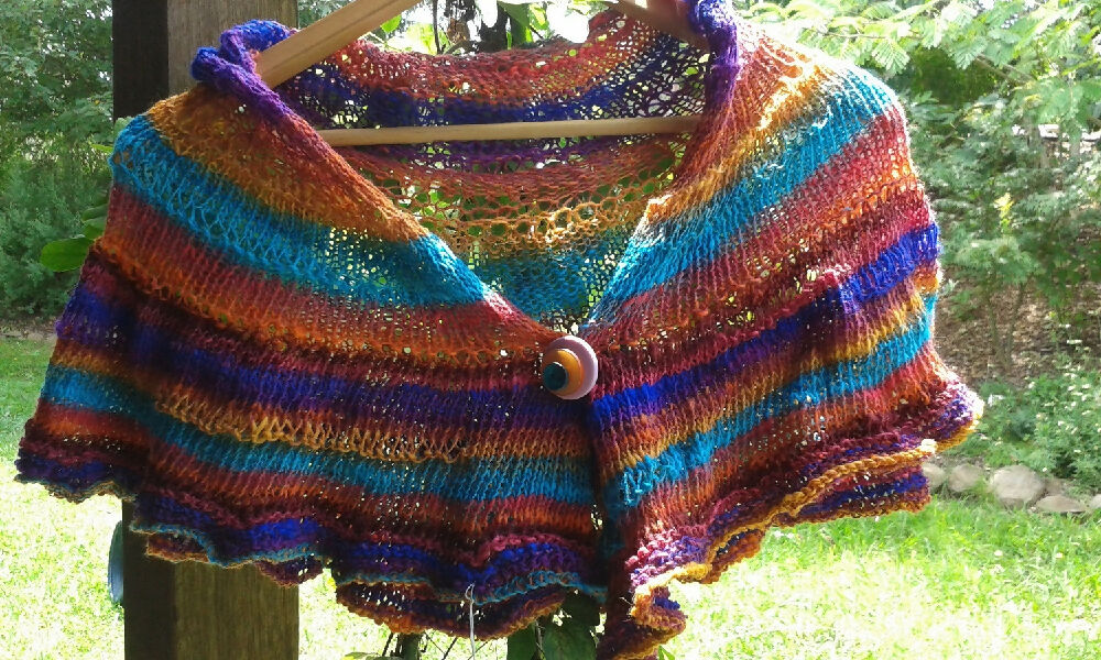 Knitted wrap made from bright silk blend yarn