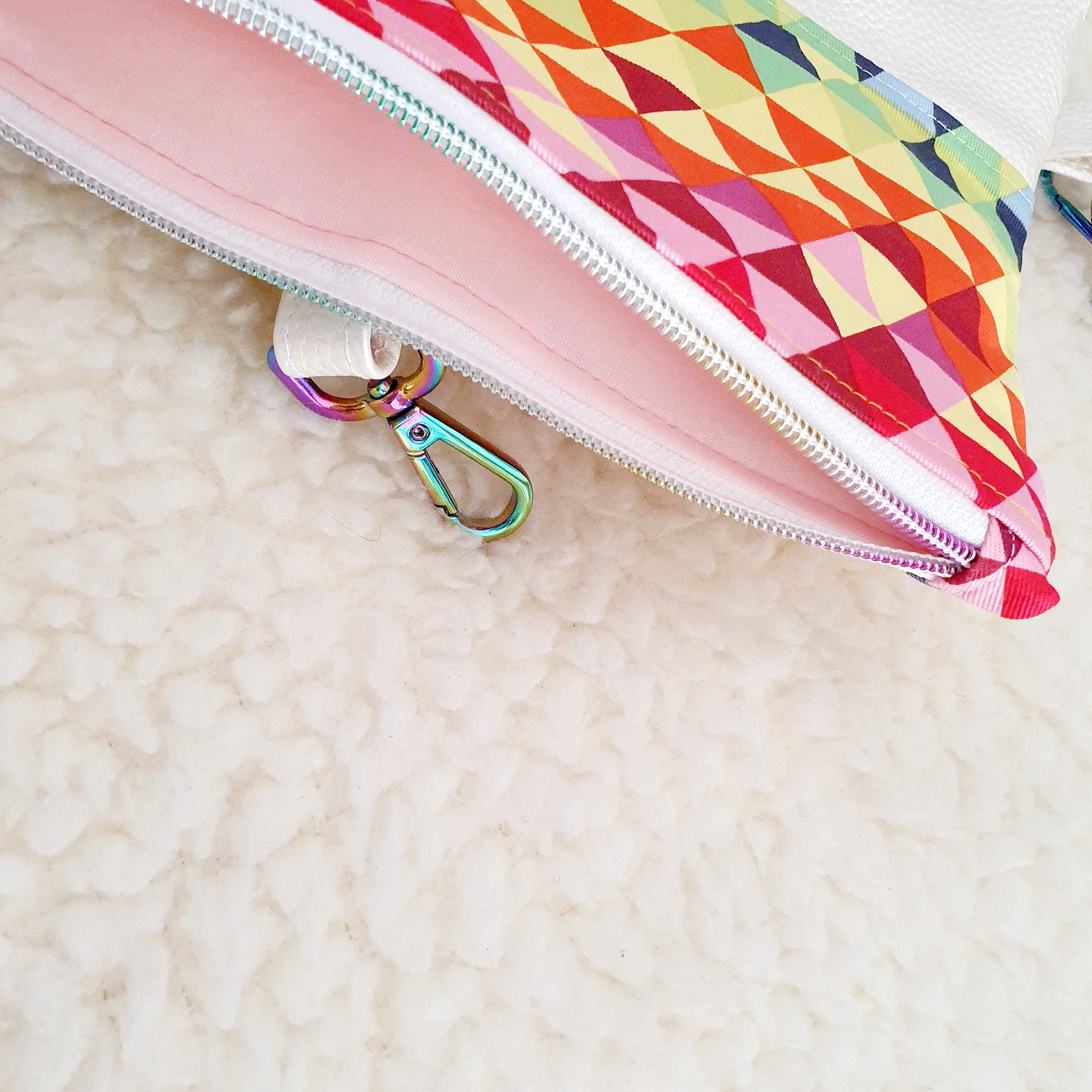 Modern, stylish white leatherette fold over zipper clutch with detachable strap