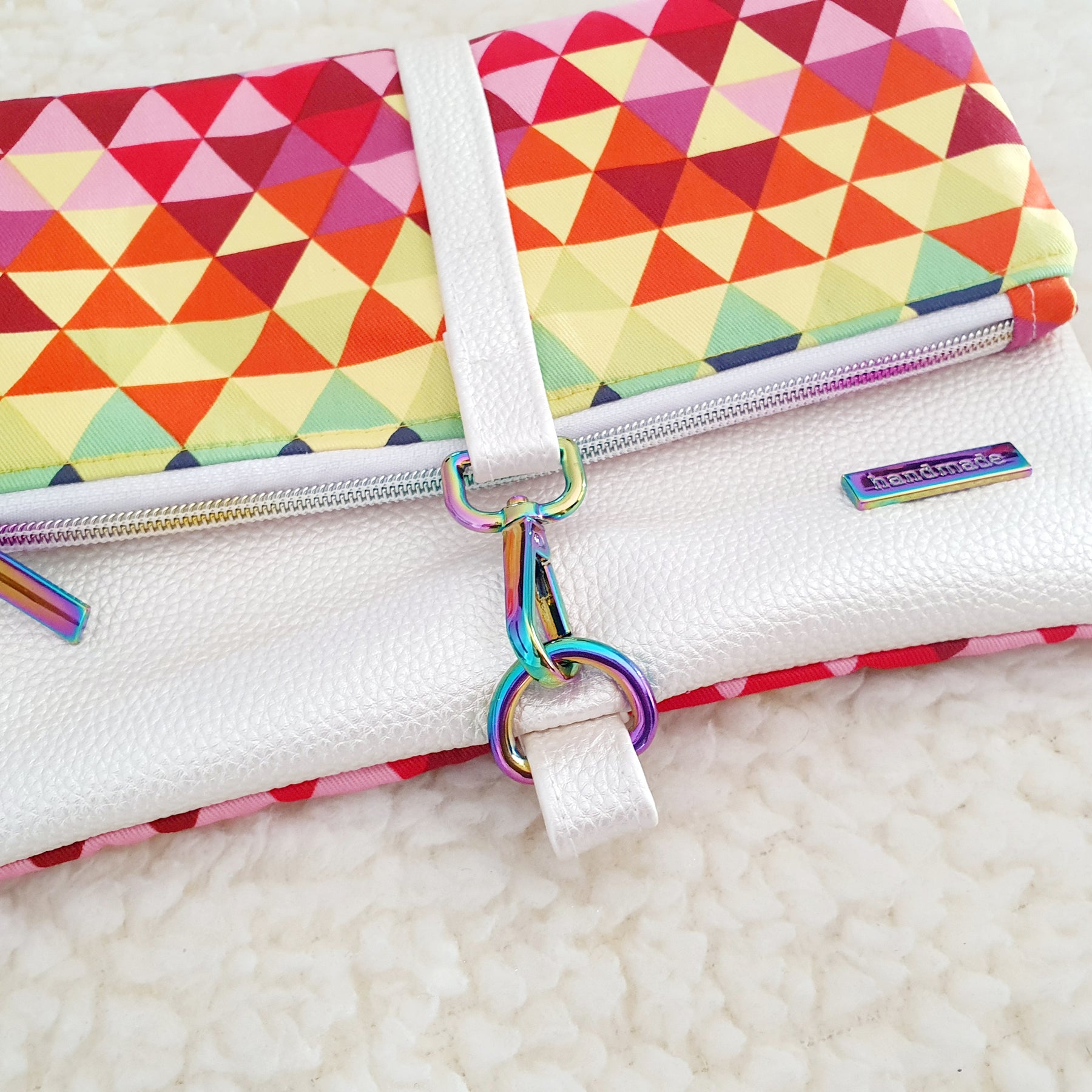 Modern, stylish white leatherette fold over zipper clutch with detachable strap