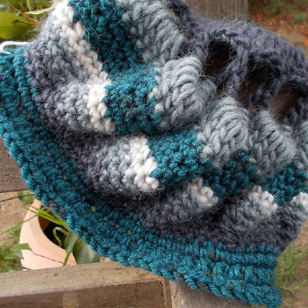 Crocheted winter hat in teal, grey and white wool