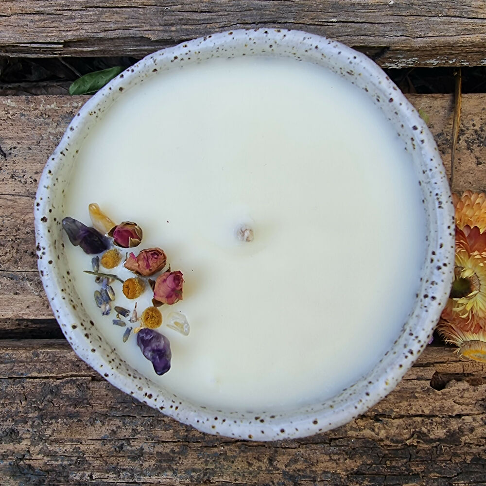 Soy candle in a speckled pottery bowl with matte white glaze