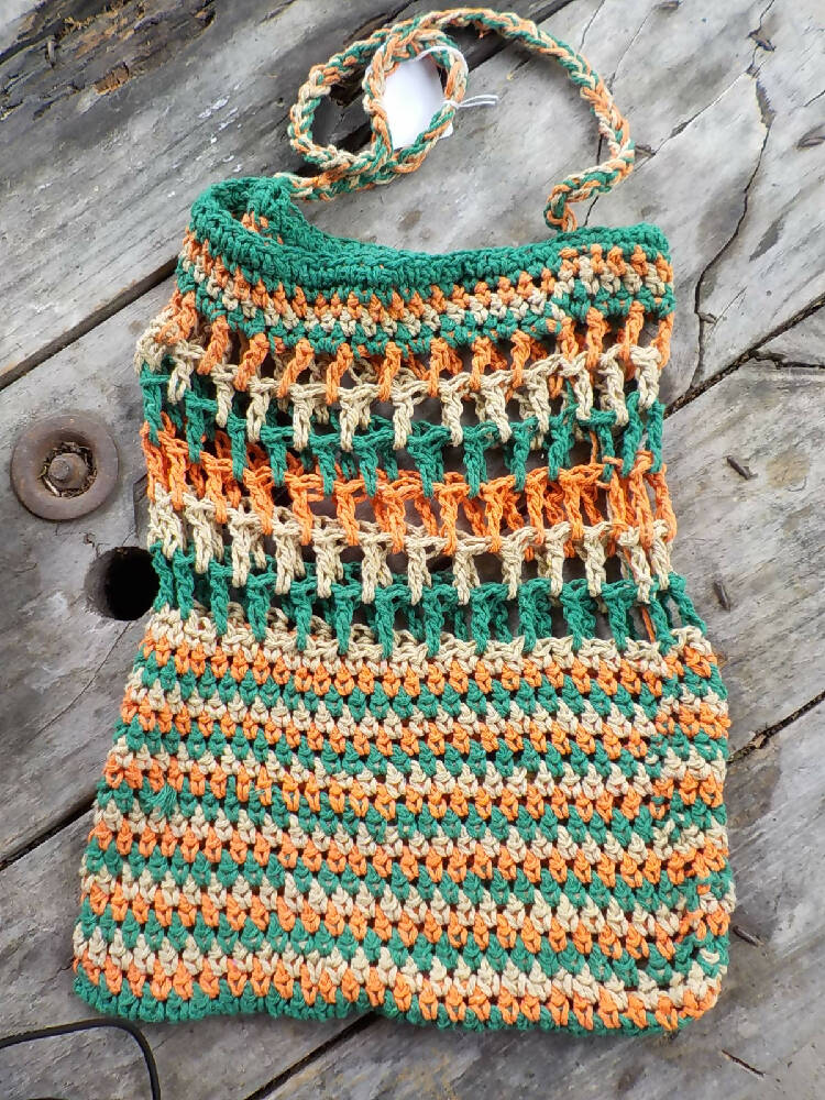 crocheted shopping carry string bag made from green, orange and beige cotton