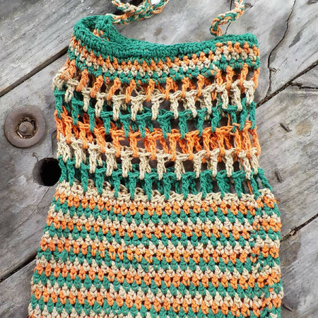 crocheted shopping carry string bag made from green, orange and beige cotton