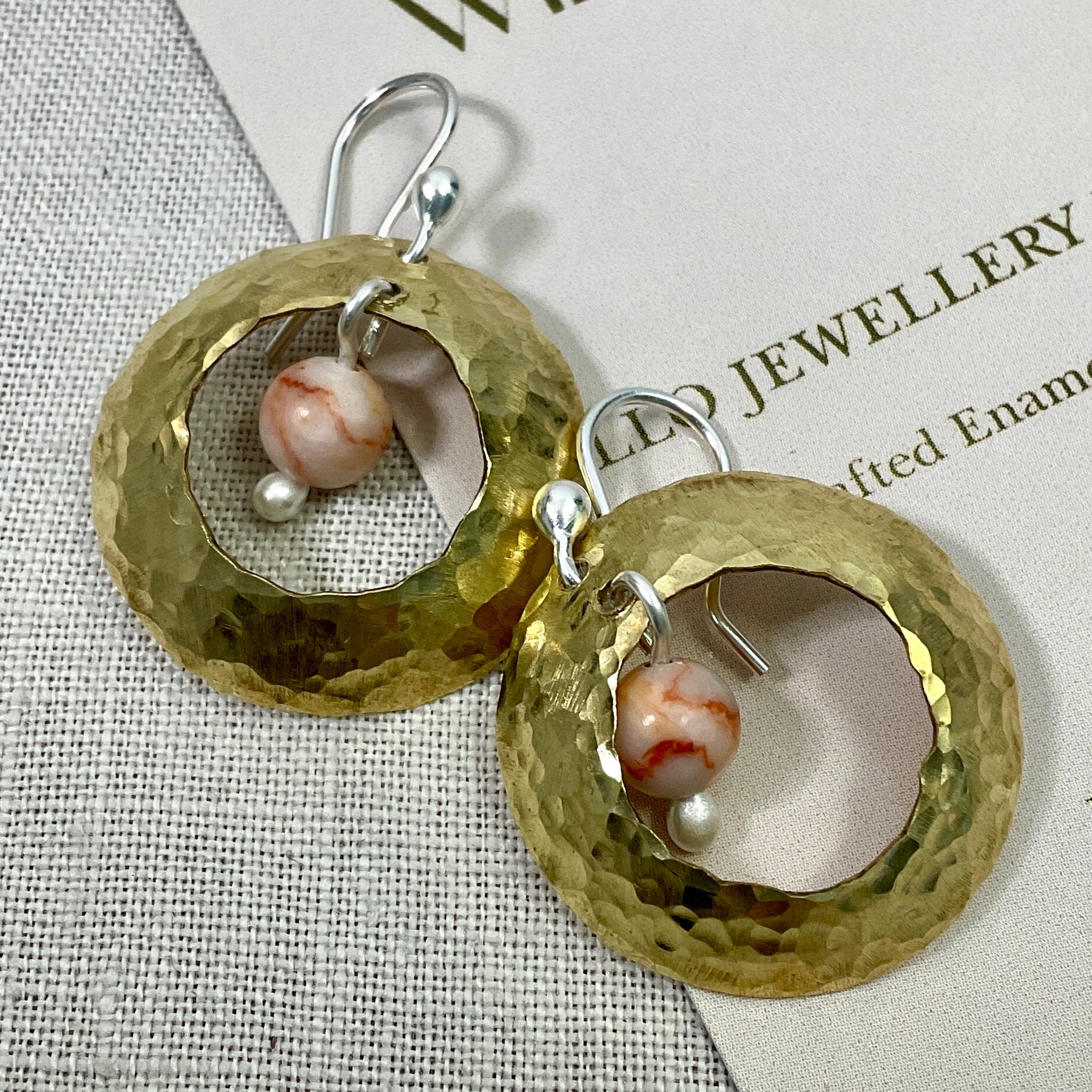 Brass domed earrings with gemstones.