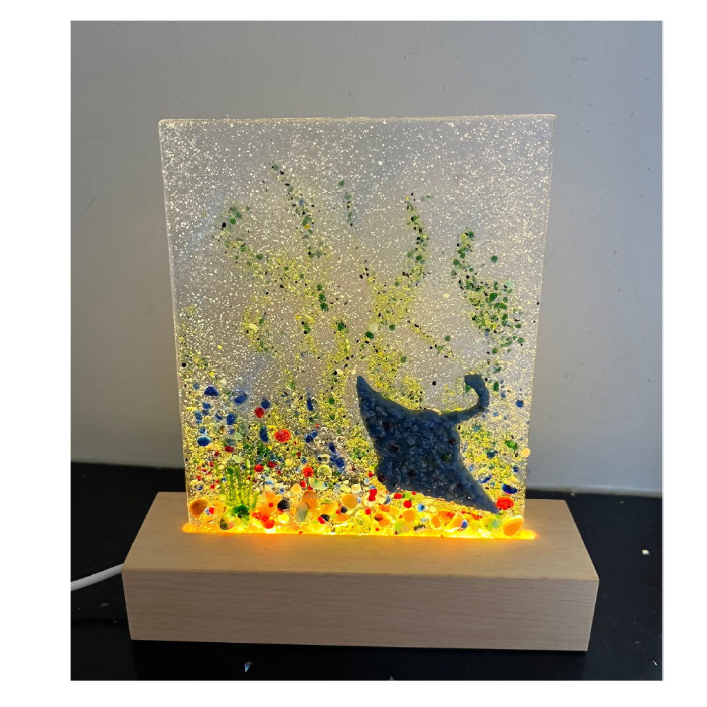 Handmade Fused Glass captivating Stunning Stingray displayed on an LED light stand.