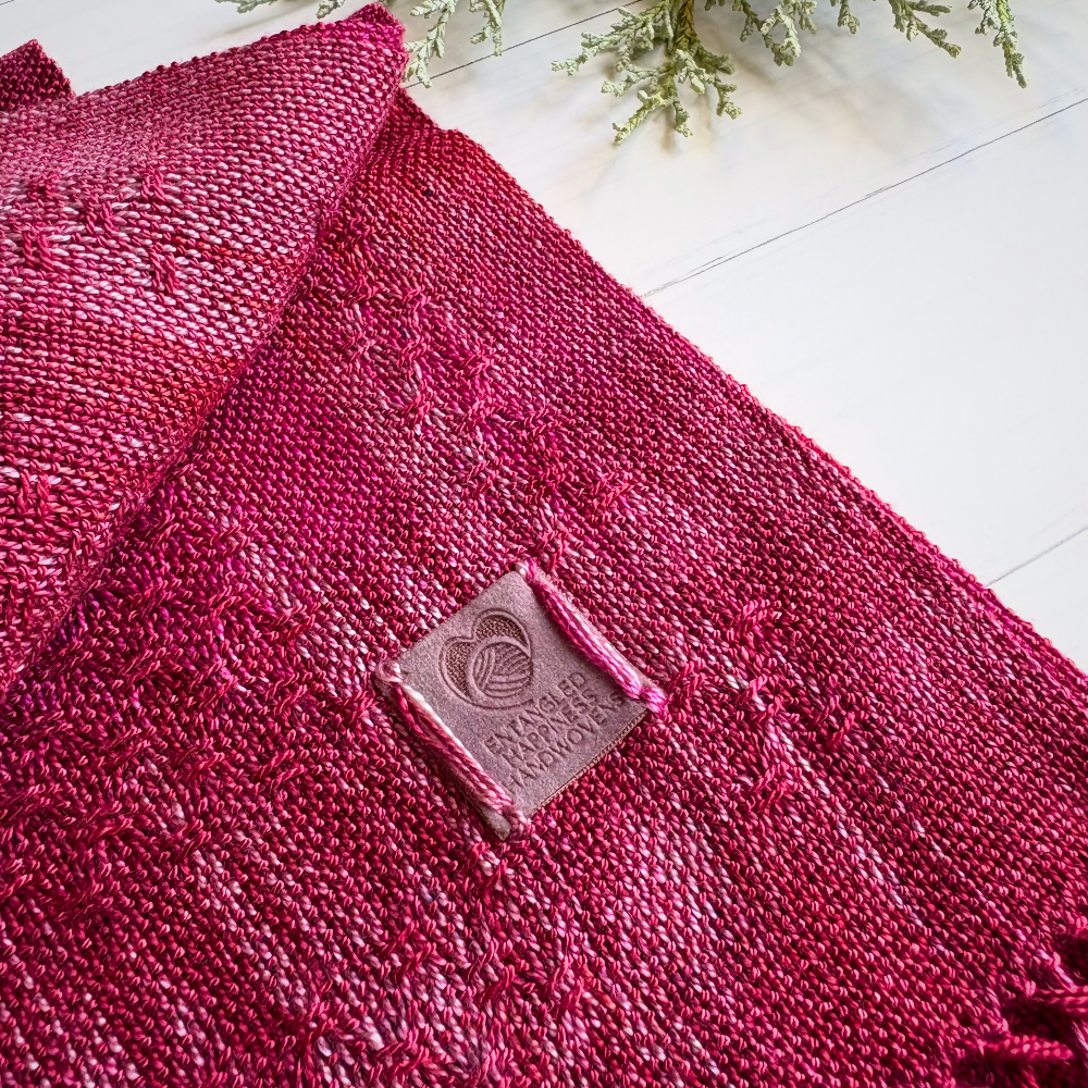 Dark-pink-tencel-scarf-folded-close-up-with-label-handwoven-entangled-happiness-handwovens