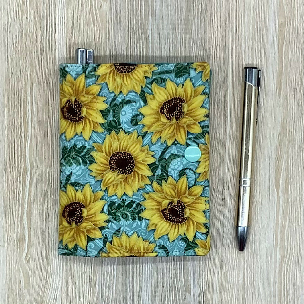 Sunflowers refillable fabric pocket notepad cover with snap closure. Incl. book and pen.