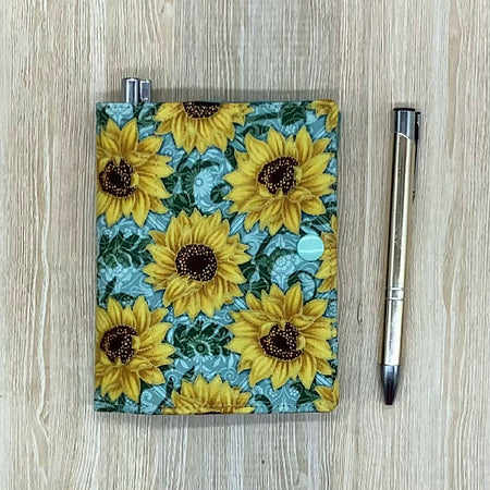 Sunflowers refillable fabric pocket notepad cover with snap closure. Incl. book and pen.