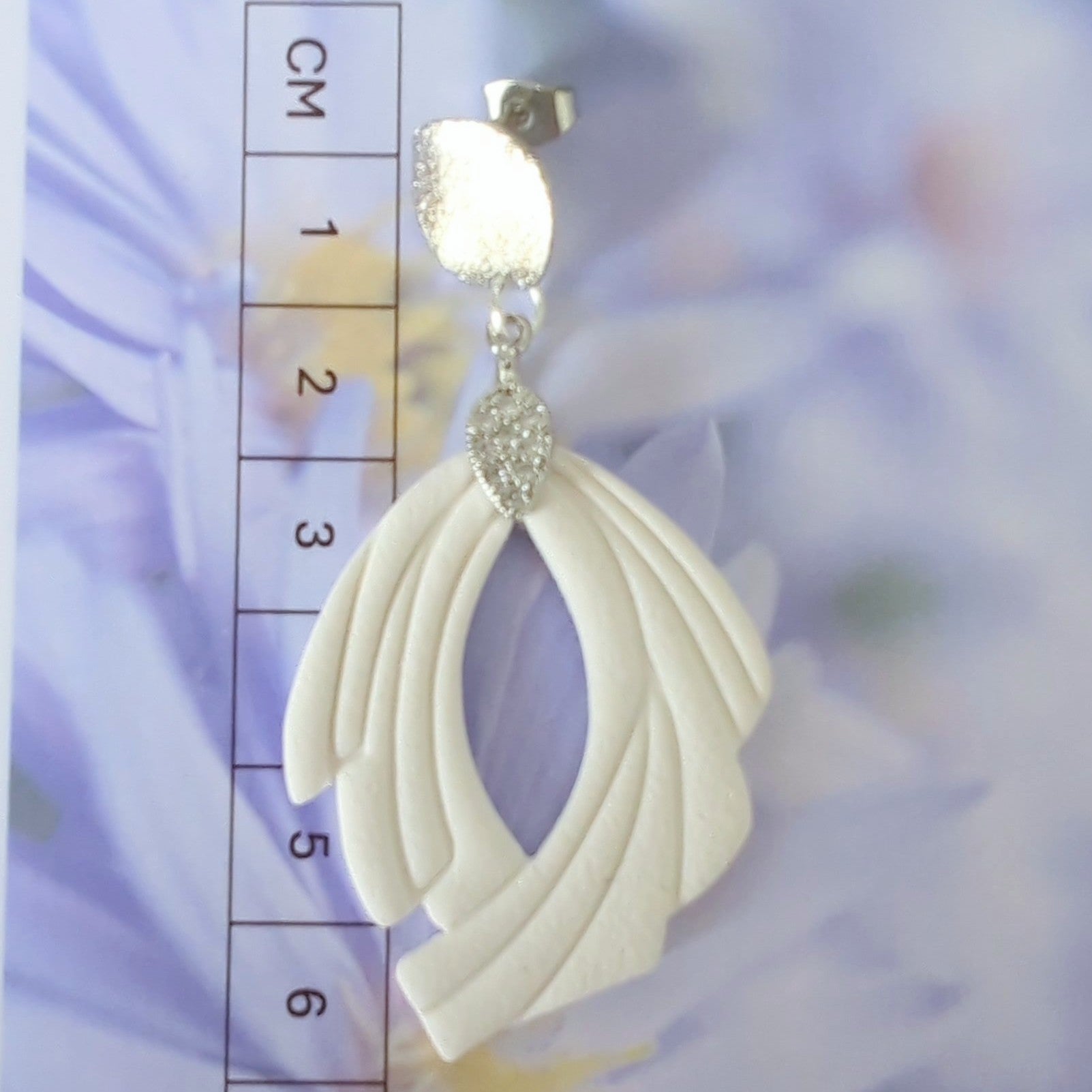 White Earrings with Silver in Different Designs.