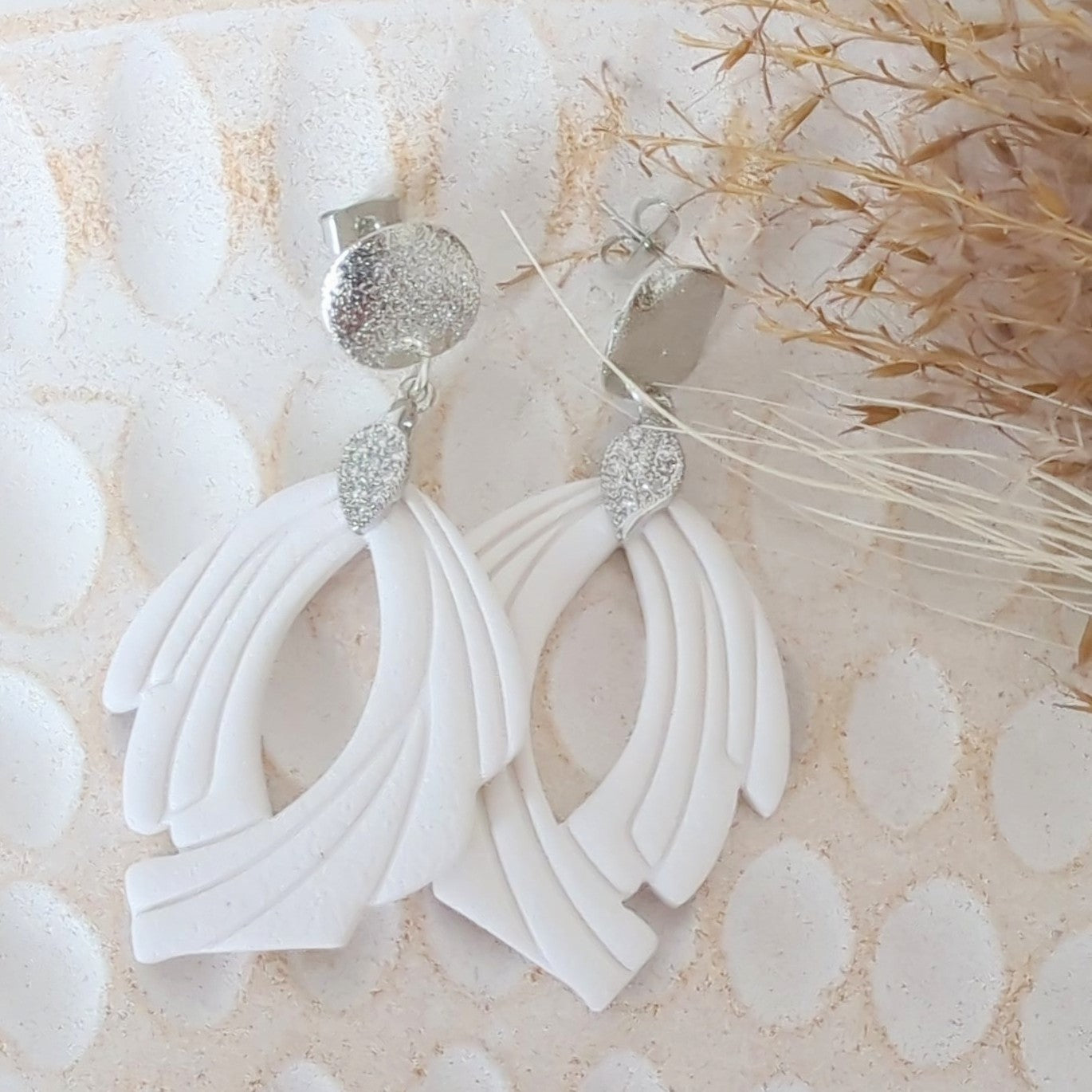 White Earrings with Silver in Different Designs.