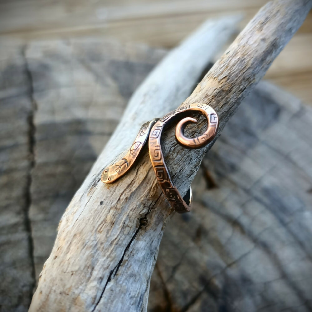 snake ring in copper on branch