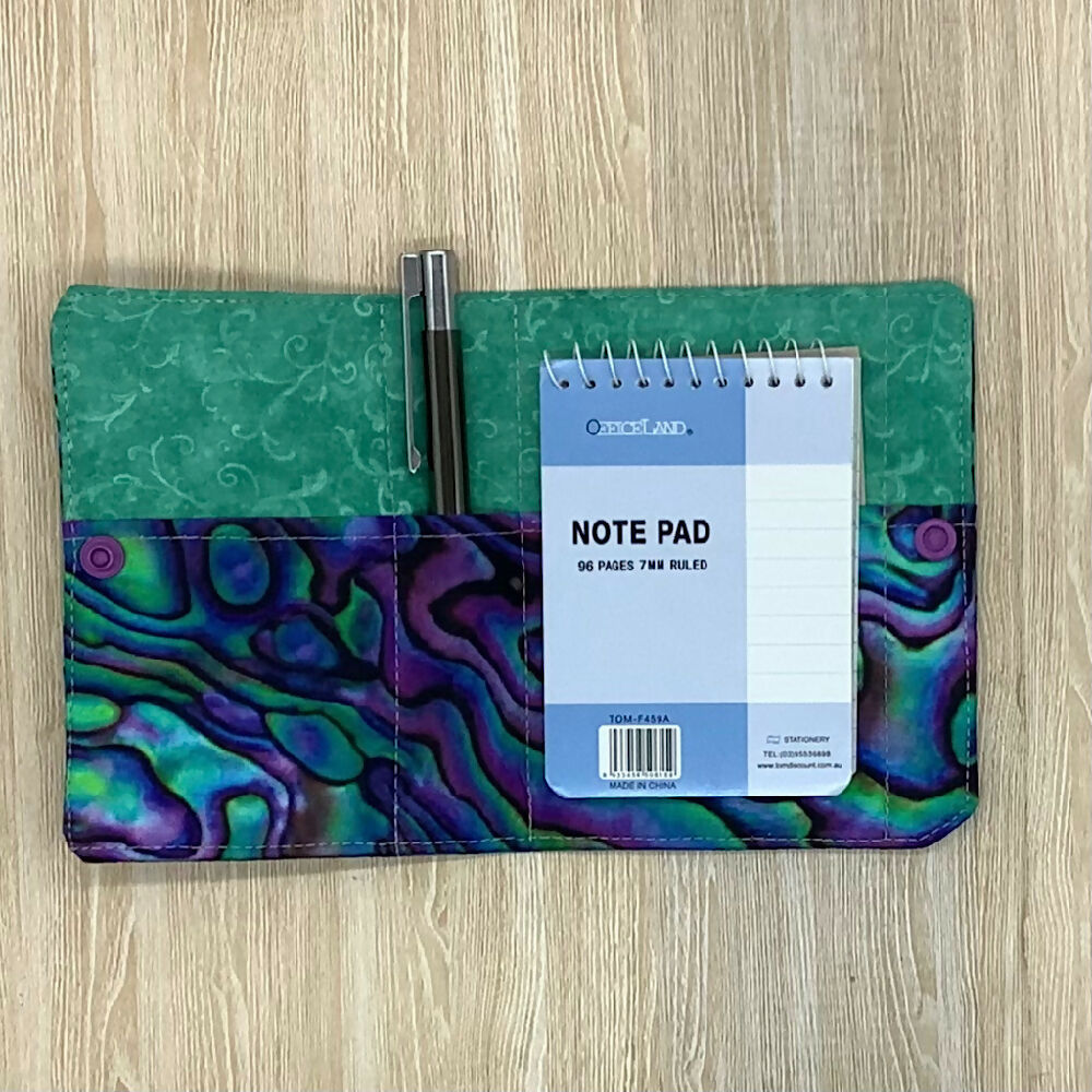 Paua shell refillable fabric pocket notepad cover with snap closure. Incl. book and pen.