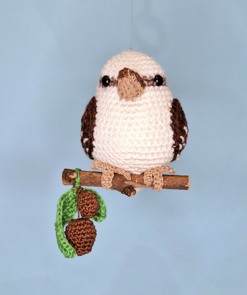 Crocheted laughing Kookaburra room decoration on perch