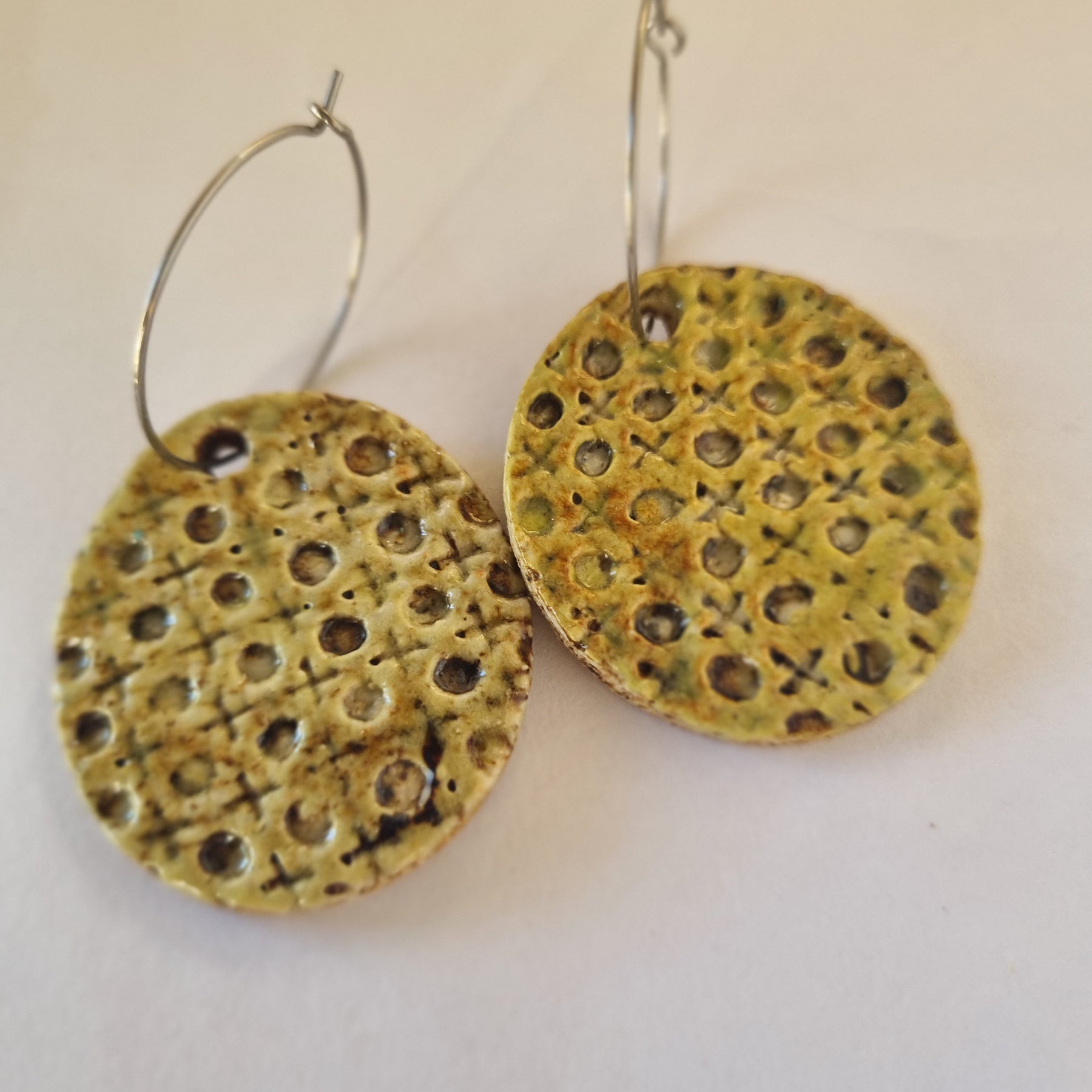 Handmade Stoneware Ceramic Earrings, muted green lattice multi-coloured, 35mm diameter, pierced ears