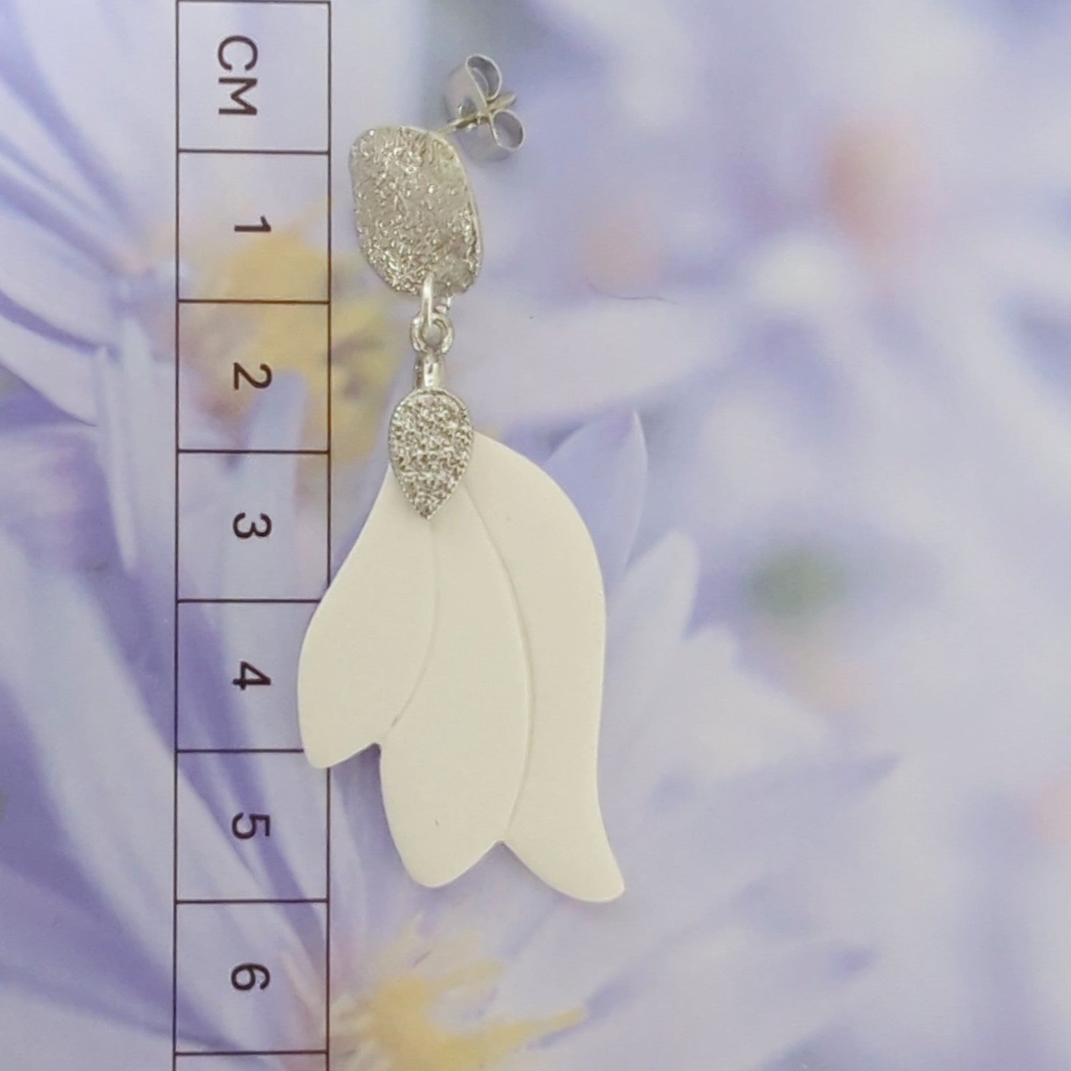 White Earrings with Silver in Different Designs.