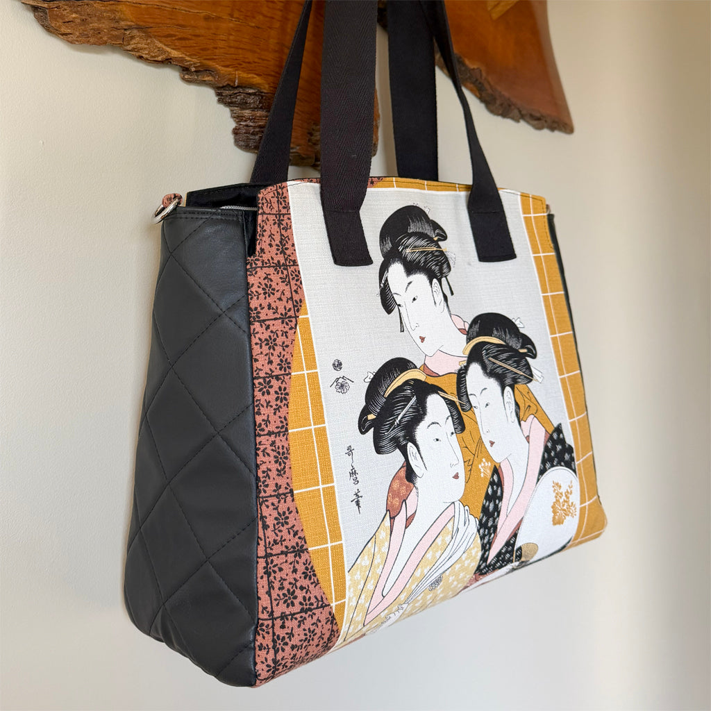 Tote-style handbag with side pockets and main zip
