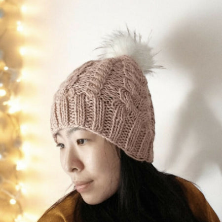 Cable Hand Knit Slouchy Beanie in beige pink with white fur pompom