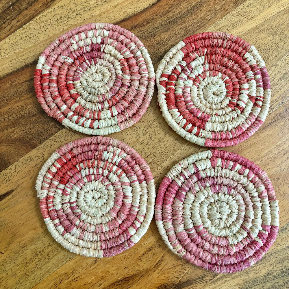 Handcrafted Raffia coasters with pink and red accents