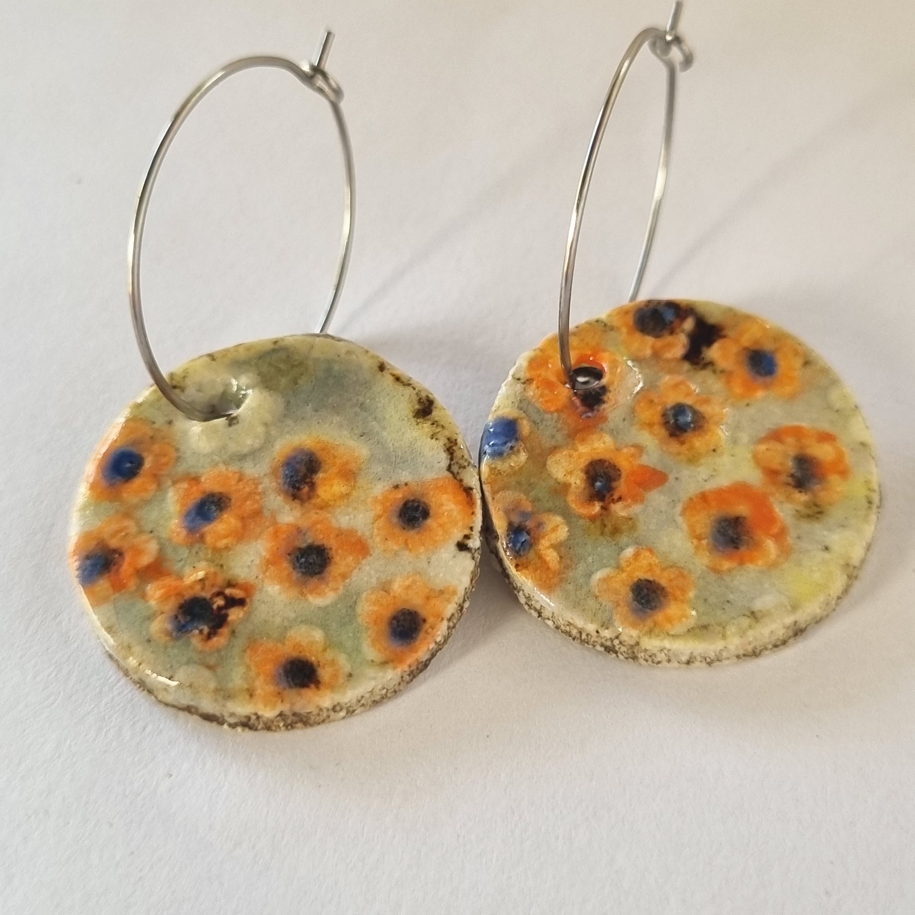 Handmade Stoneware Ceramic Earrings, orange floral multi-coloured, 28mm diameter, pierced ears