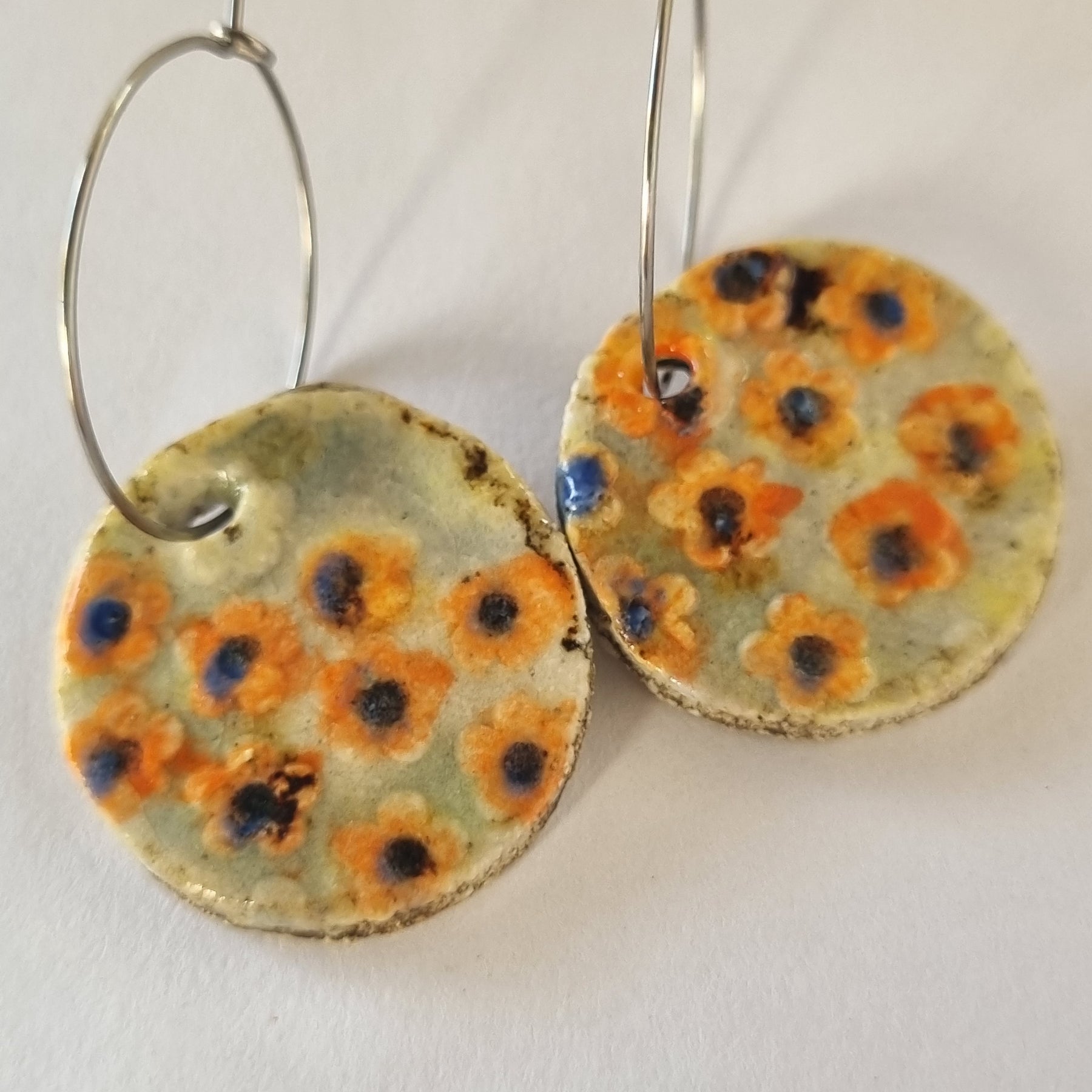 Handmade Stoneware Ceramic Earrings, orange floral multi-coloured, 28mm diameter, pierced ears
