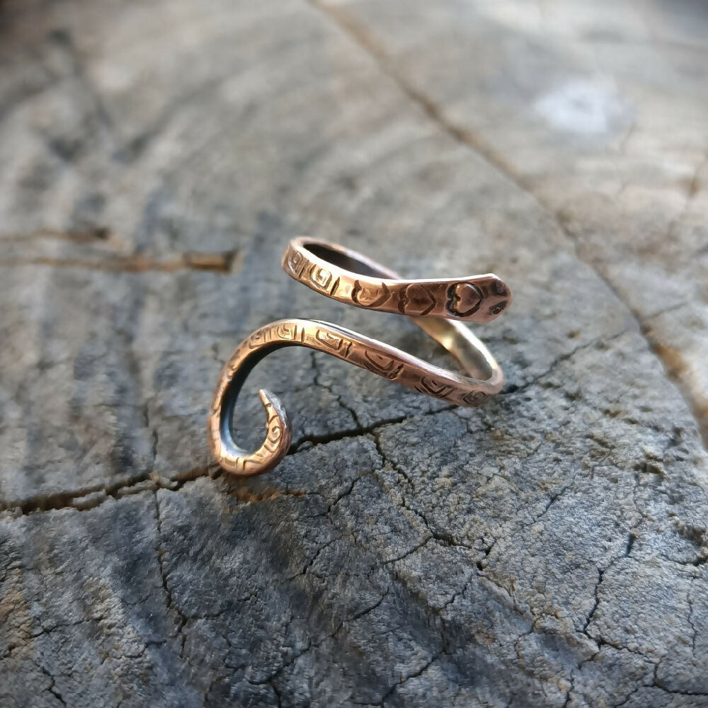 snake ring copper heart on wood base