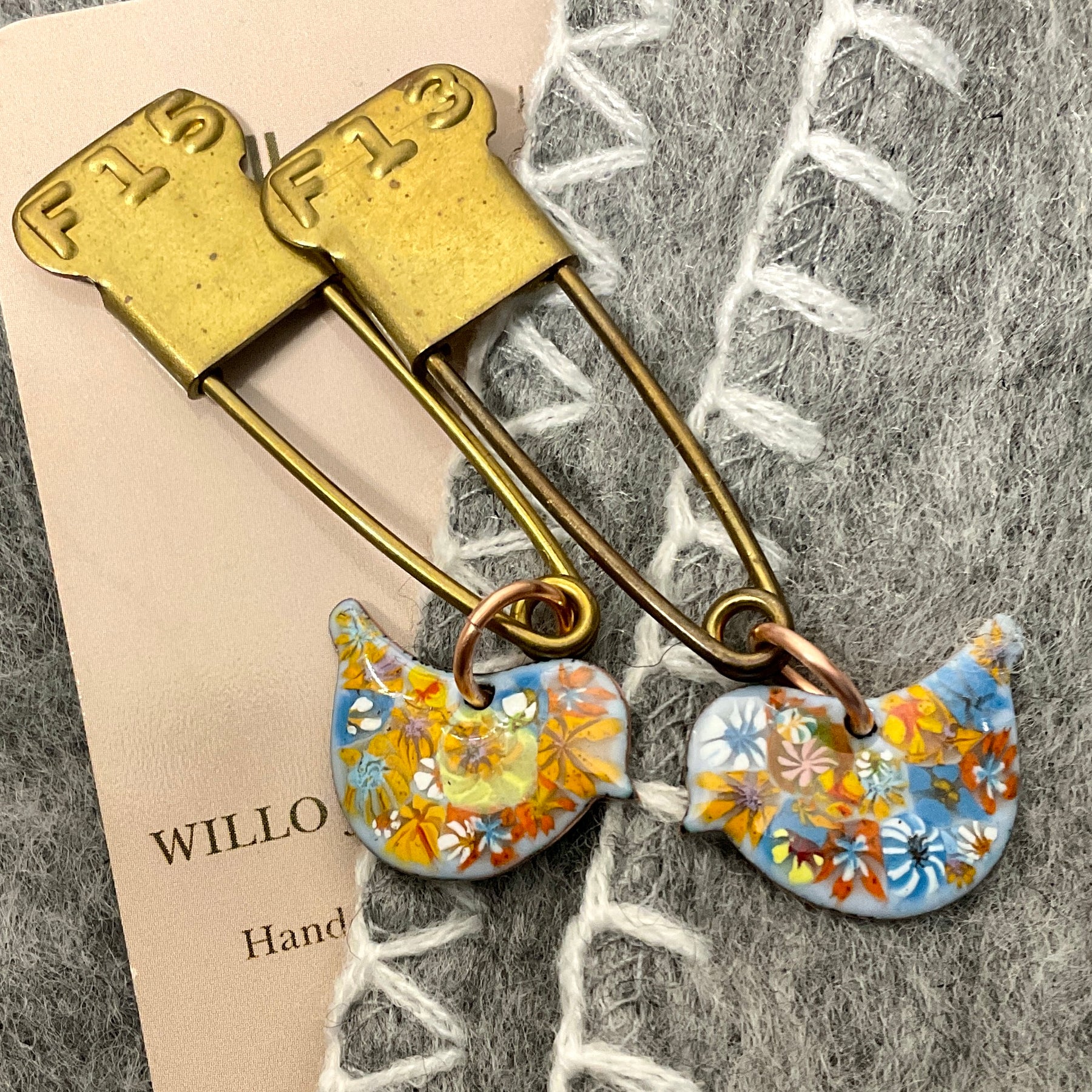Bird scarf pin.