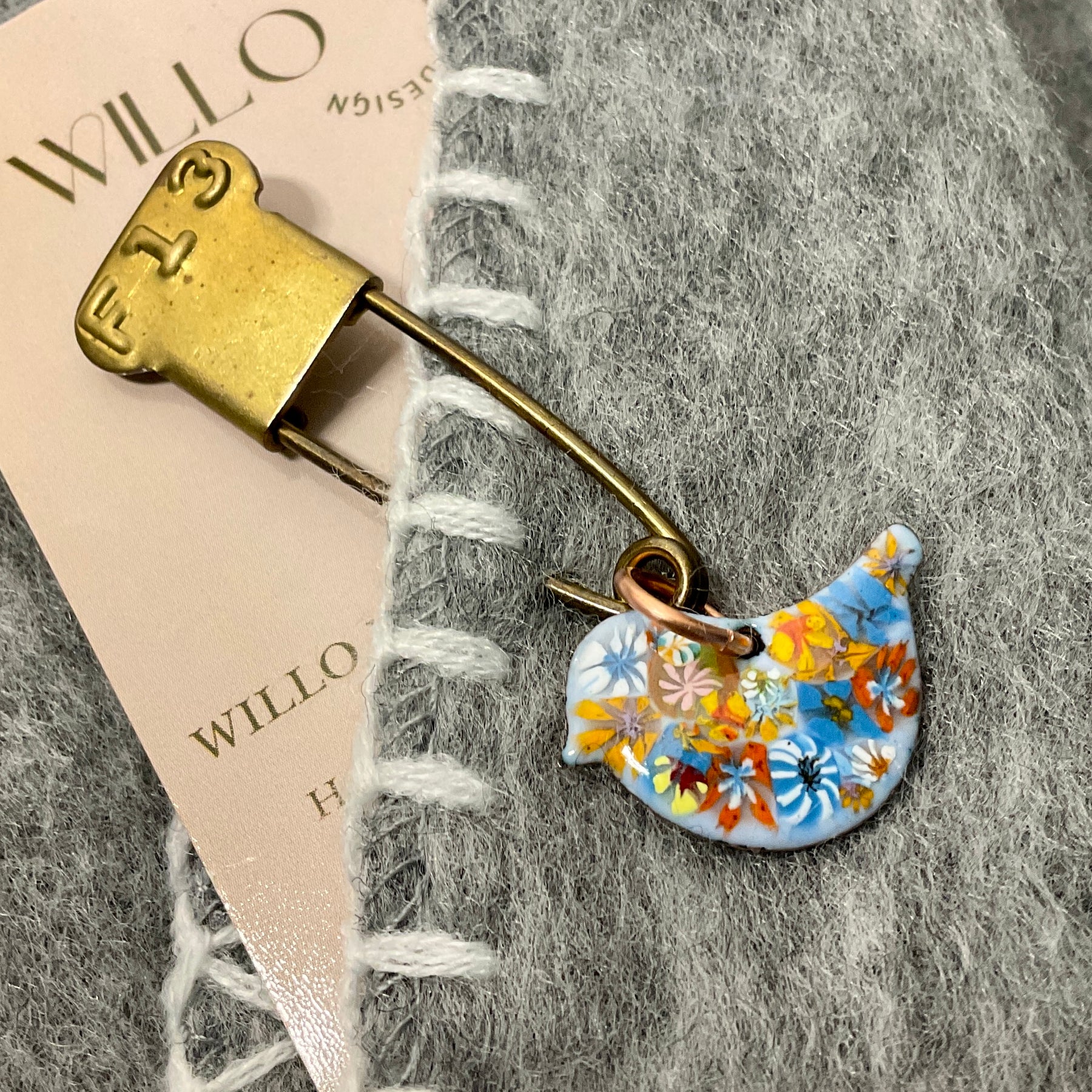 Bird scarf pin.