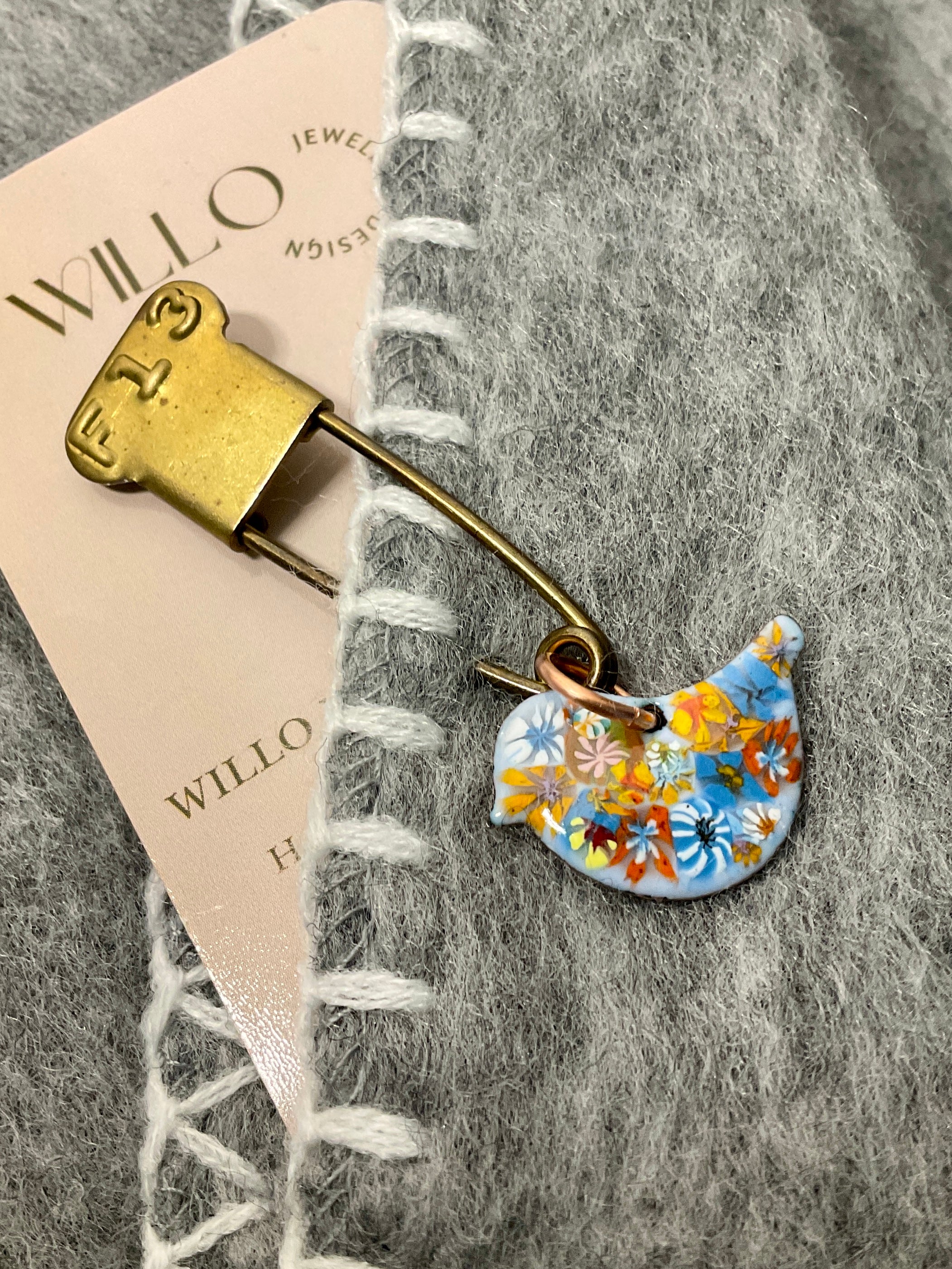Bird scarf pin.