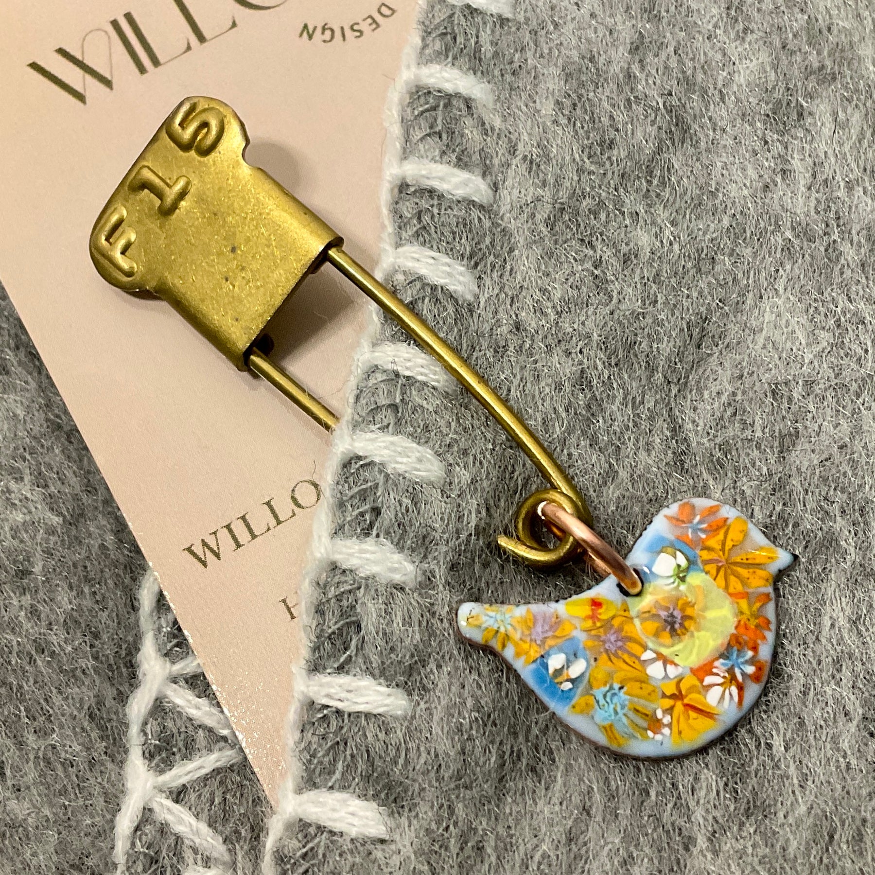 Bird scarf pin.