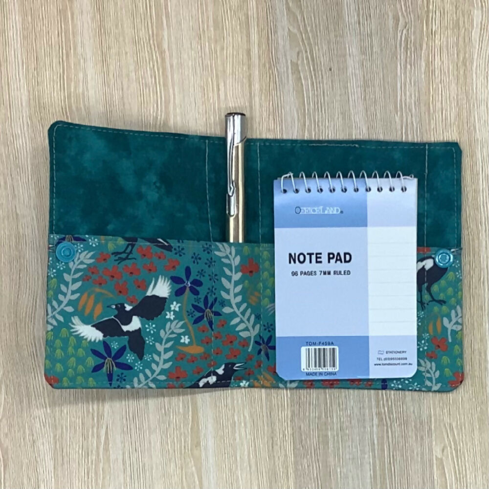 Magpie refillable fabric pocket notepad cover with snap closure. Incl. book and pen.