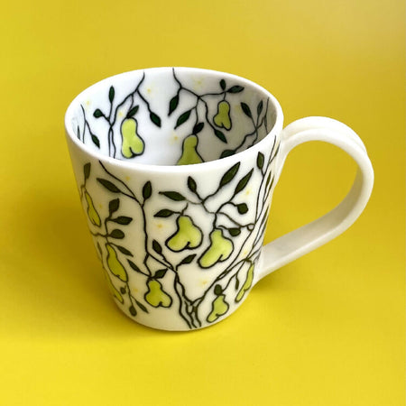 Handmade porcelain ceramic cup with pear design