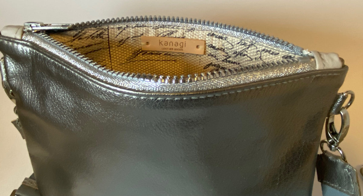 Metallic silver zip top crossbody bag