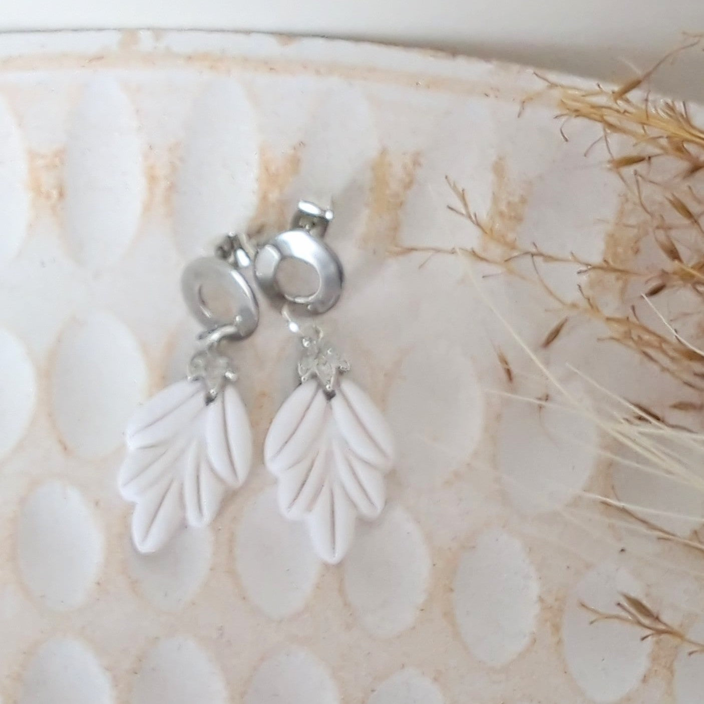 White Earrings with Silver in Different Designs.