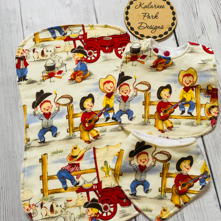 ''Lil Cowpokes'' on Cream Back ground Bib Set Includes Regular Bib Bandana Bib and Burp Cloth