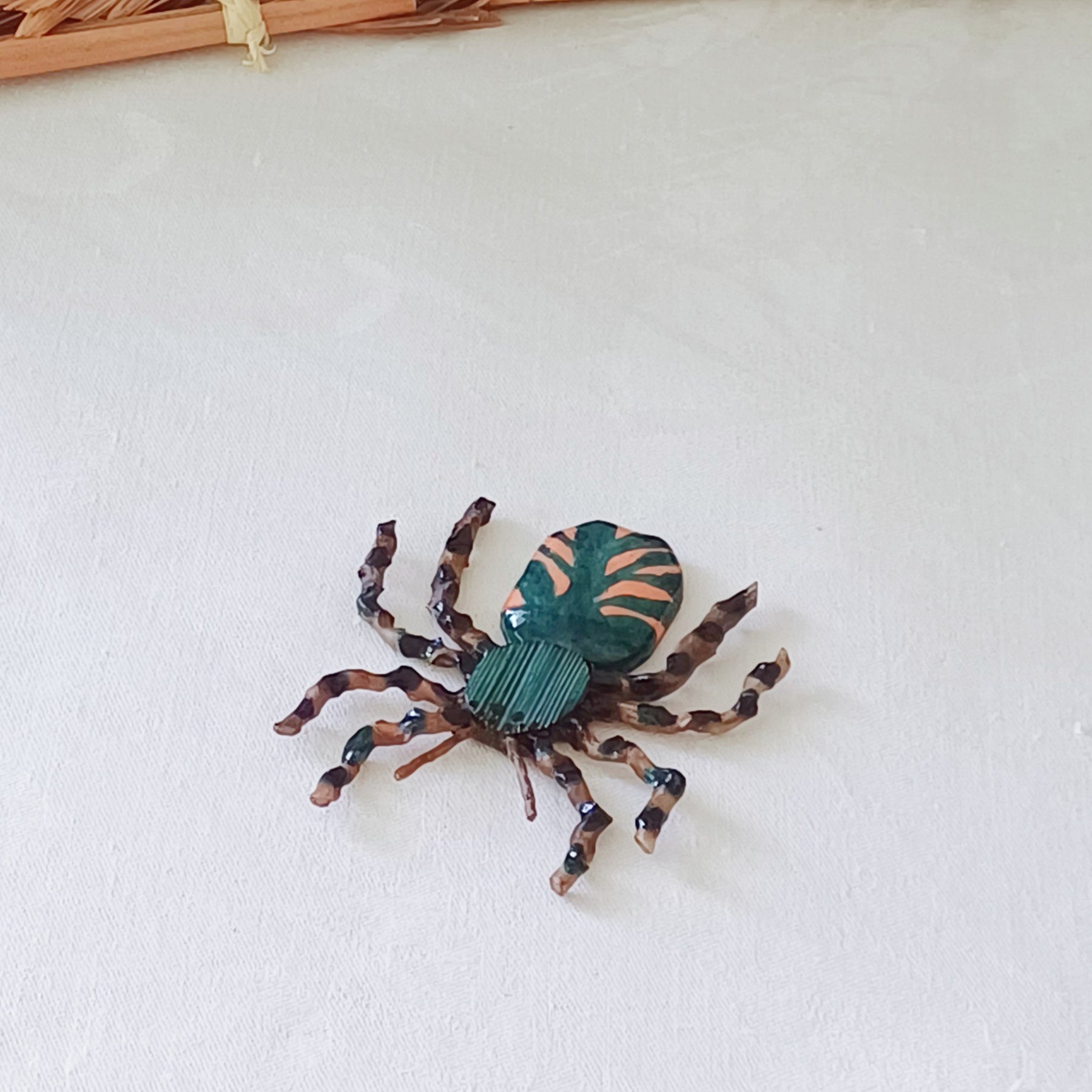 Hand painted teal palm leaf clay spider keepsake with magnet