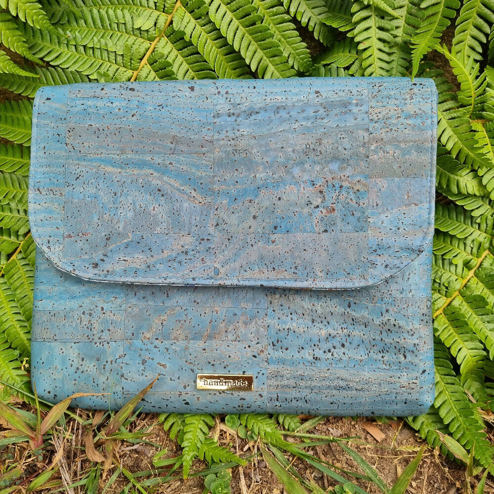 iPad cover or clutch in cork. The front view shows a curved flap.