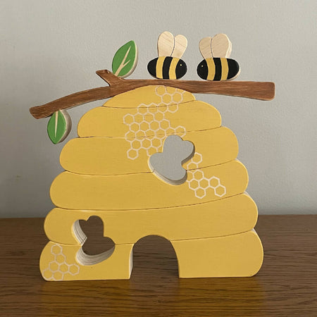 Wooden Beehive stacking puzzle with 2 bees.