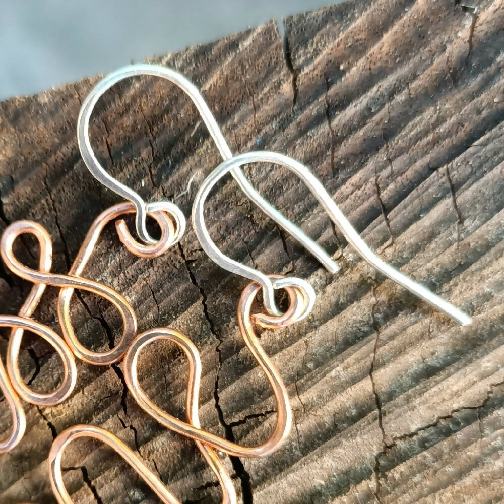 copper earrings with silver earwire hooks close up