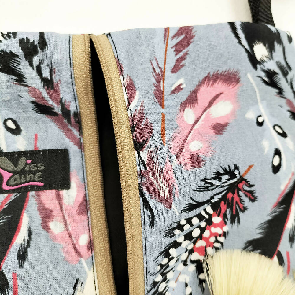 Feather print waterproof bag with adjustable strap. Toiletry bag