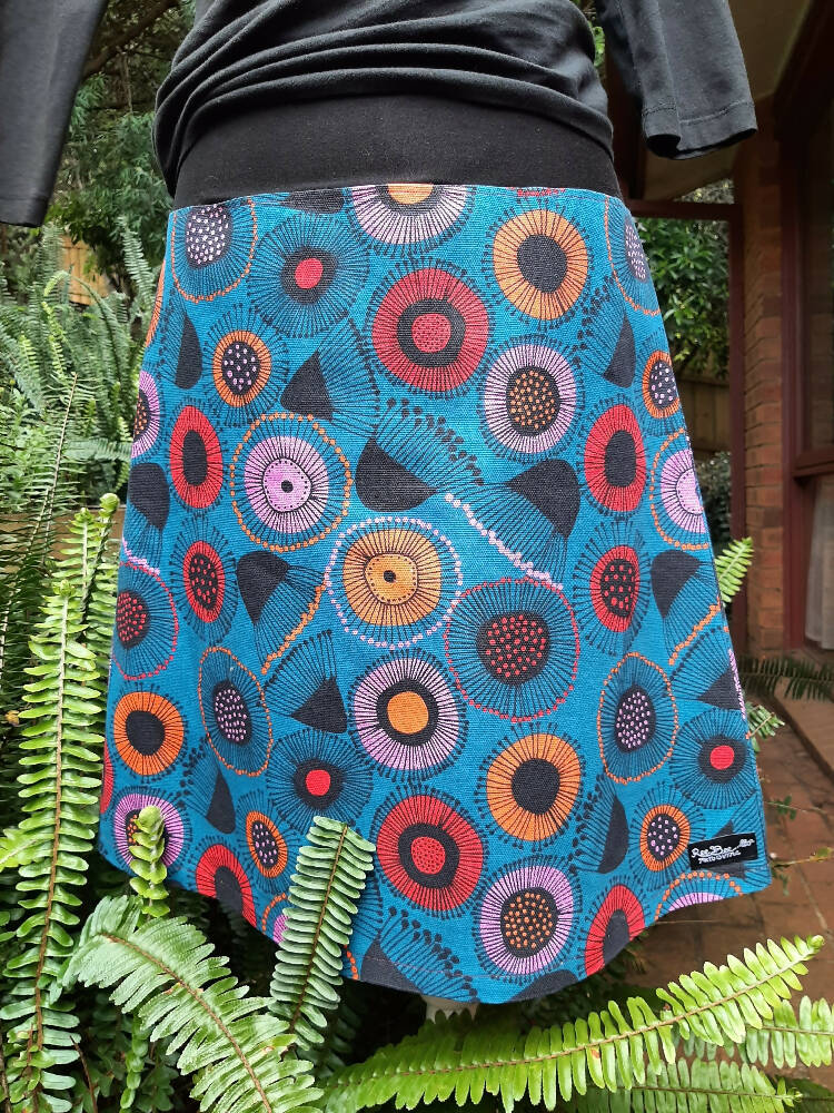 Blue skirt with orange, red and pink gum blossoms