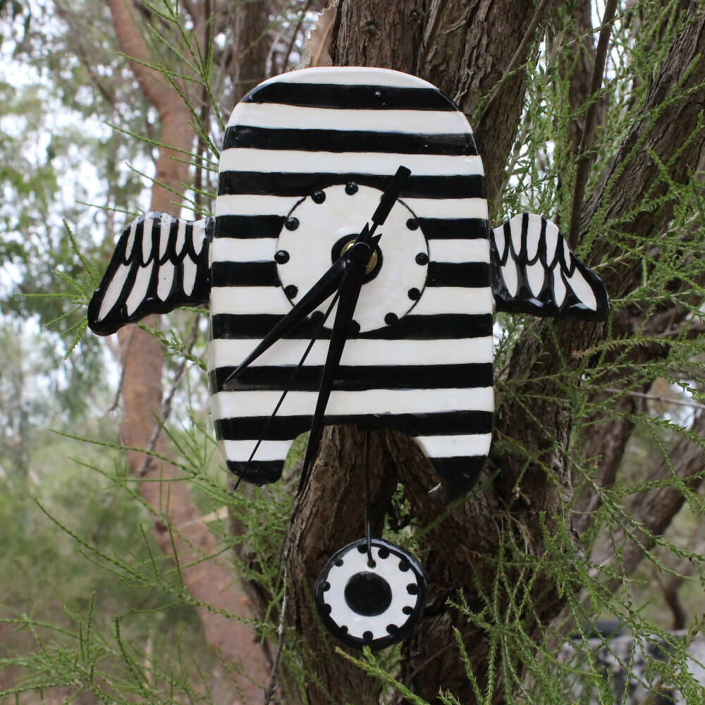 stripey black and white clock, clay, ceramic with wings