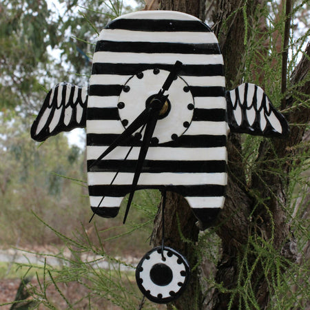 stripey black and white clock, clay, ceramic with wings