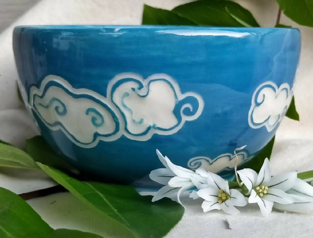 Blue sky, white clouds. Small hand made condement bowl