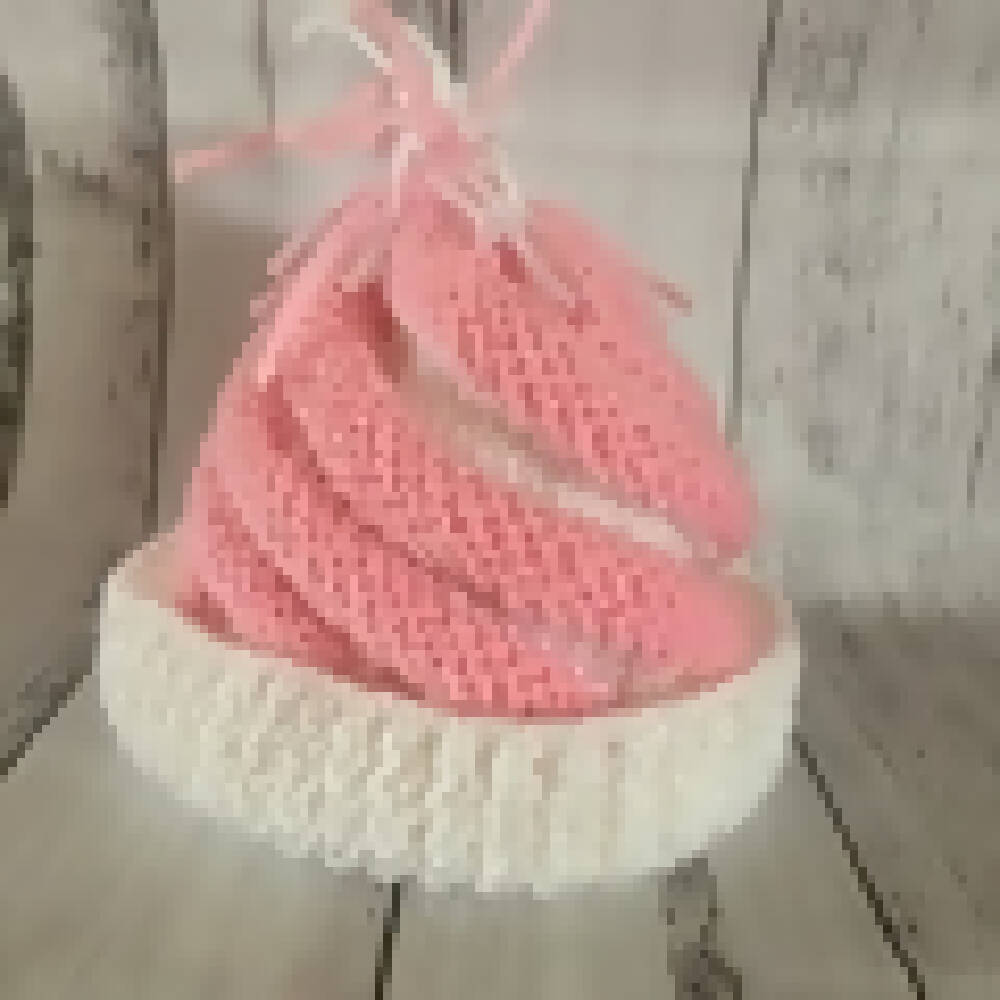 Pink and white knitted beanie and ugg booties.