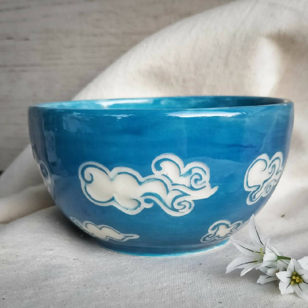 Blue sky, white clouds. Small hand made condement bowl