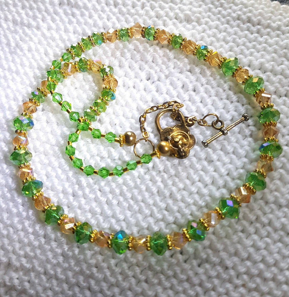 Crystal necklace, green and gold with gold clasp